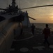 USCGC Bertholf crew clears the flight deck for arrive al US Navy HSC-6 helicopter