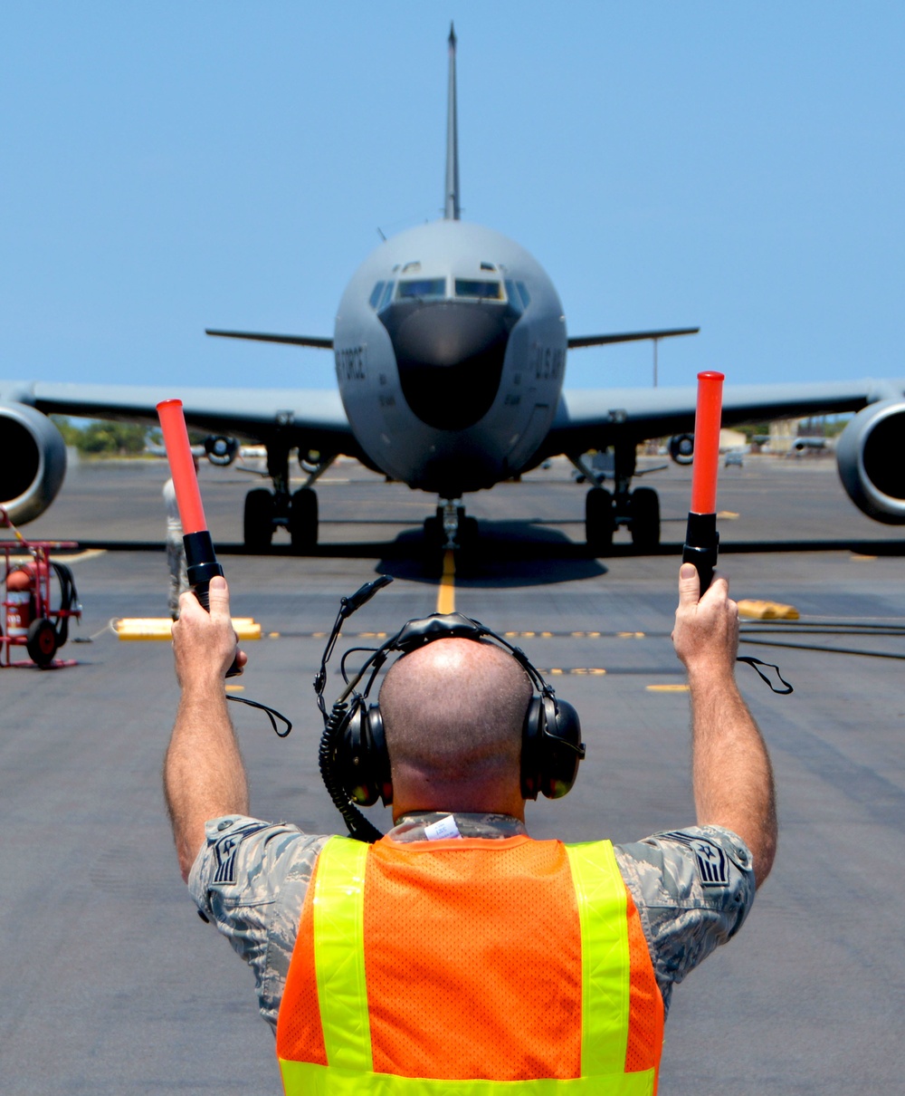 507th Aircraft Maintenance Squadron marshals a 97th Air Mobility Wing KC-135 for RIMPAC 2018