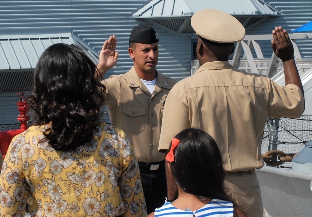 Family members watch a re-enlistment aboard the USS Wisconsin