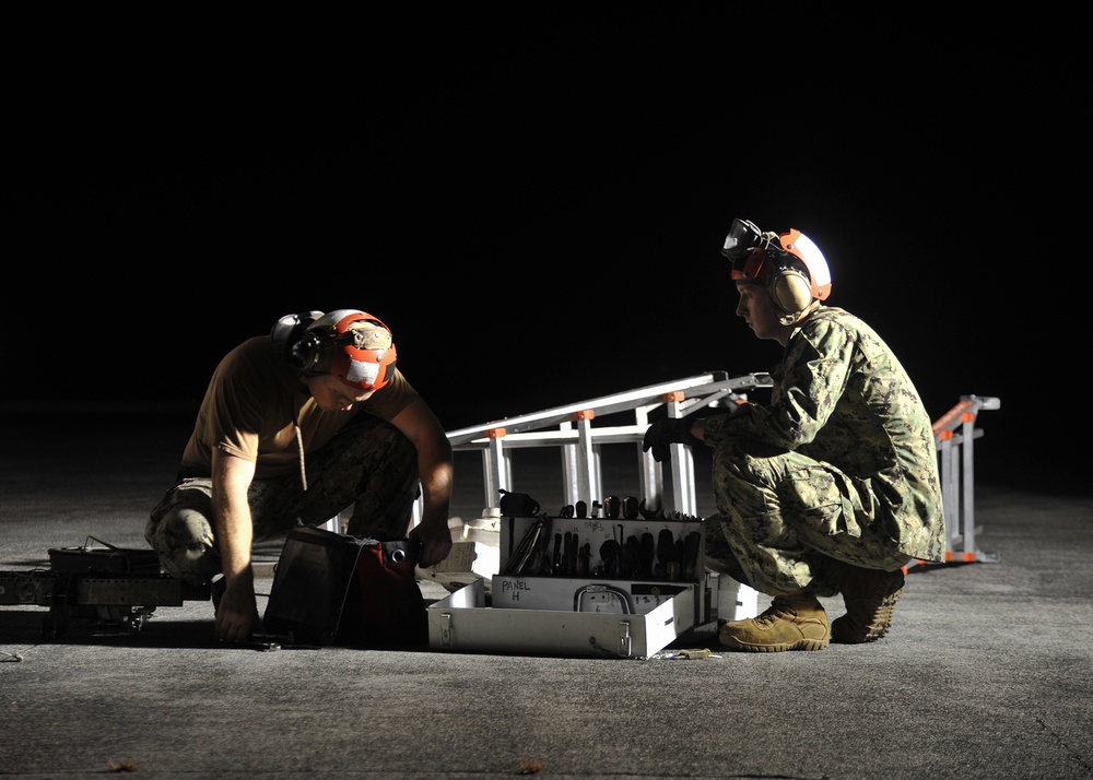 Patrol squadron Sailors upload Maverick missiles on P-3Cs during RIMPAC 2018