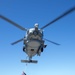 USS Antietam (CG 54) Sailors prepare to attach a cargo hook to a MH-60R Sea Hawk helicopter from “Warlords” of HSM 51