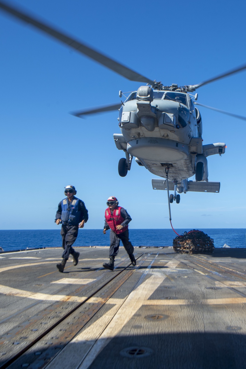 USS Antietam (CG 54) Sailors egress after securing a cargo hook to a MH-60R Sea Hawk helicopter from “Warlords” of HSM 51