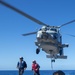 USS Antietam (CG 54) Sailors egress after securing a cargo hook to a MH-60R Sea Hawk helicopter from “Warlords” of HSM 51