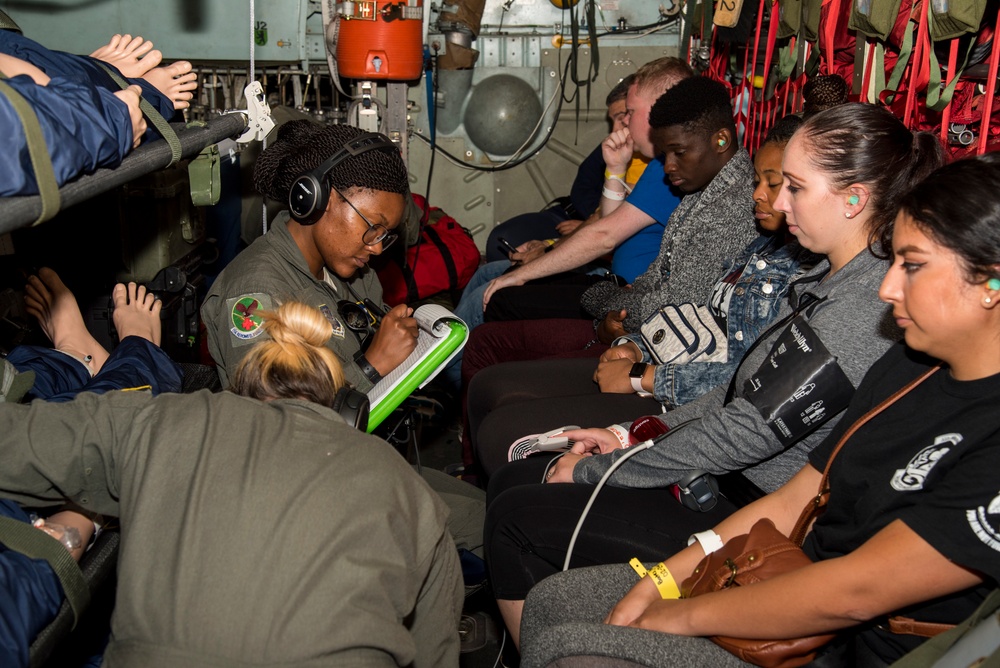 flight medics check vitals in a C-130 Hercules