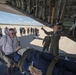 A flight nurse loads medical patients on a C-130 Hercules