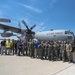 Emergency responders take photo in front of C-130 Hercules