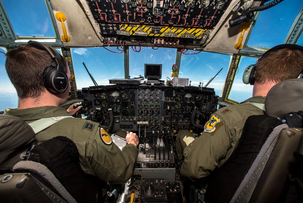 Pilots fly a C-130 Hercules