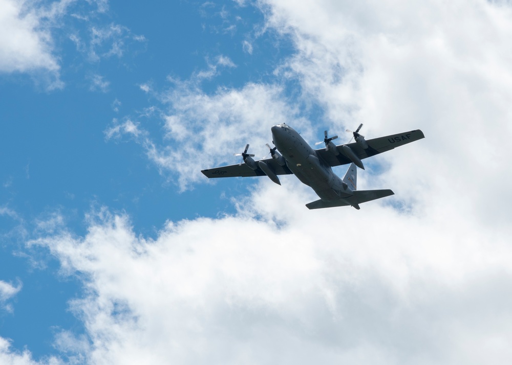 Airmen drop cargo from a C-130 Hercules