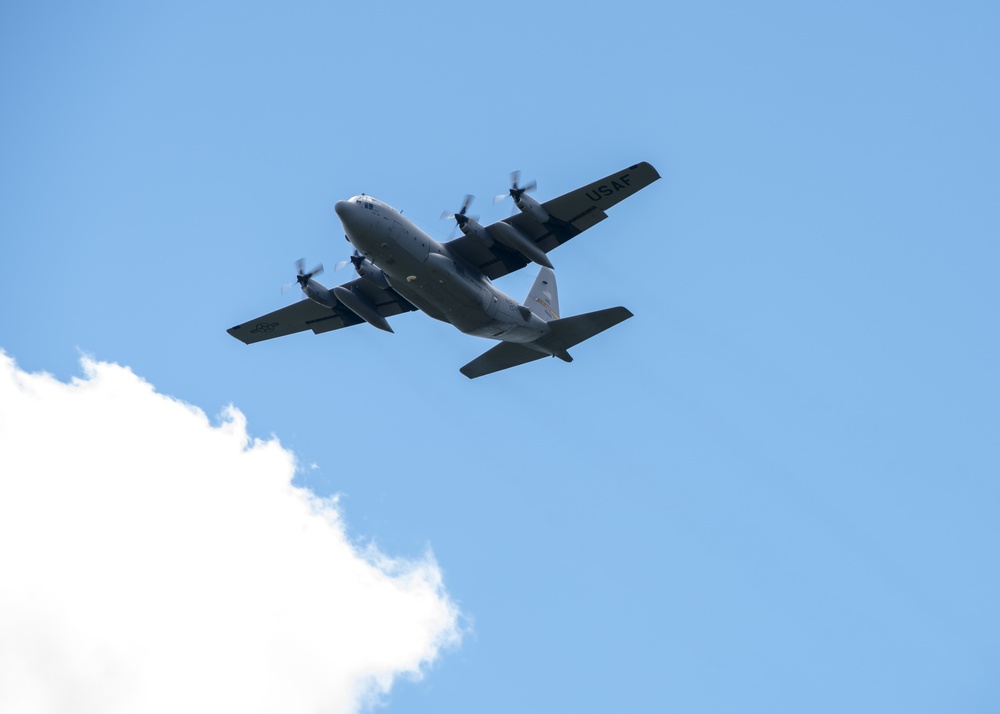 Airmen drop cargo from a C-130 Hercules