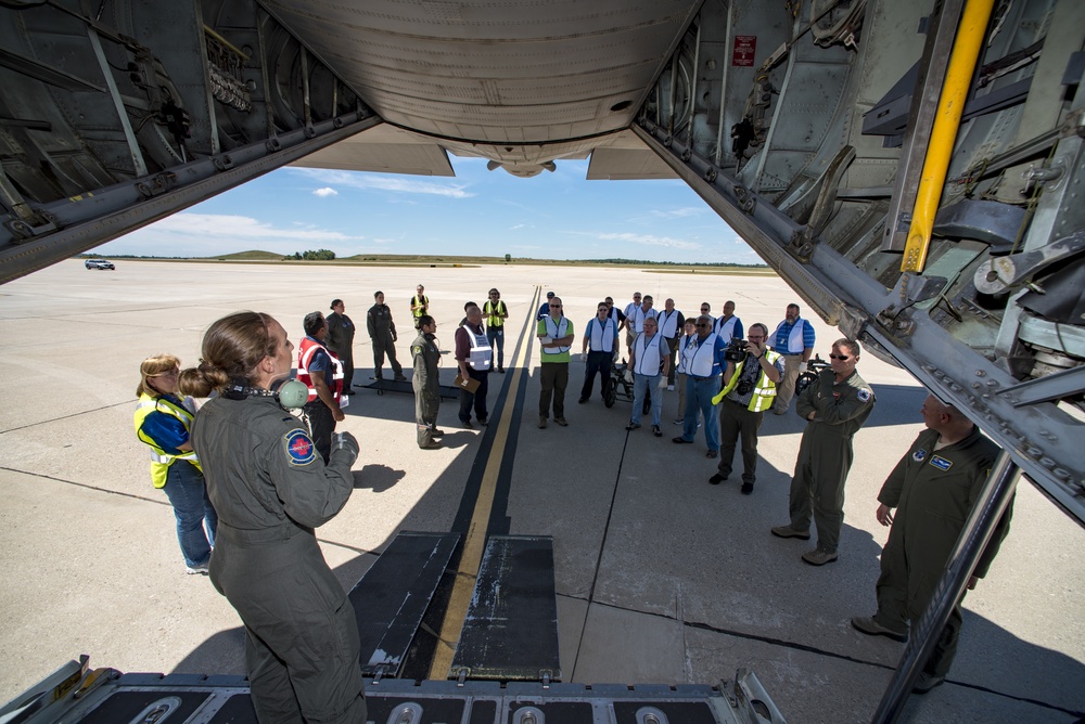 A flight nurse gives instructions on off-loading patients from a C-130 Hercules