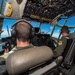Pilots fly a C-130 Hercules