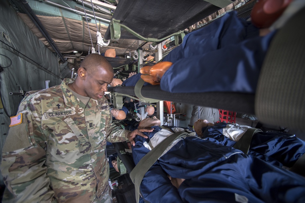 A chaplain simulates a session with medical patients in-flight a C-130 Hercules
