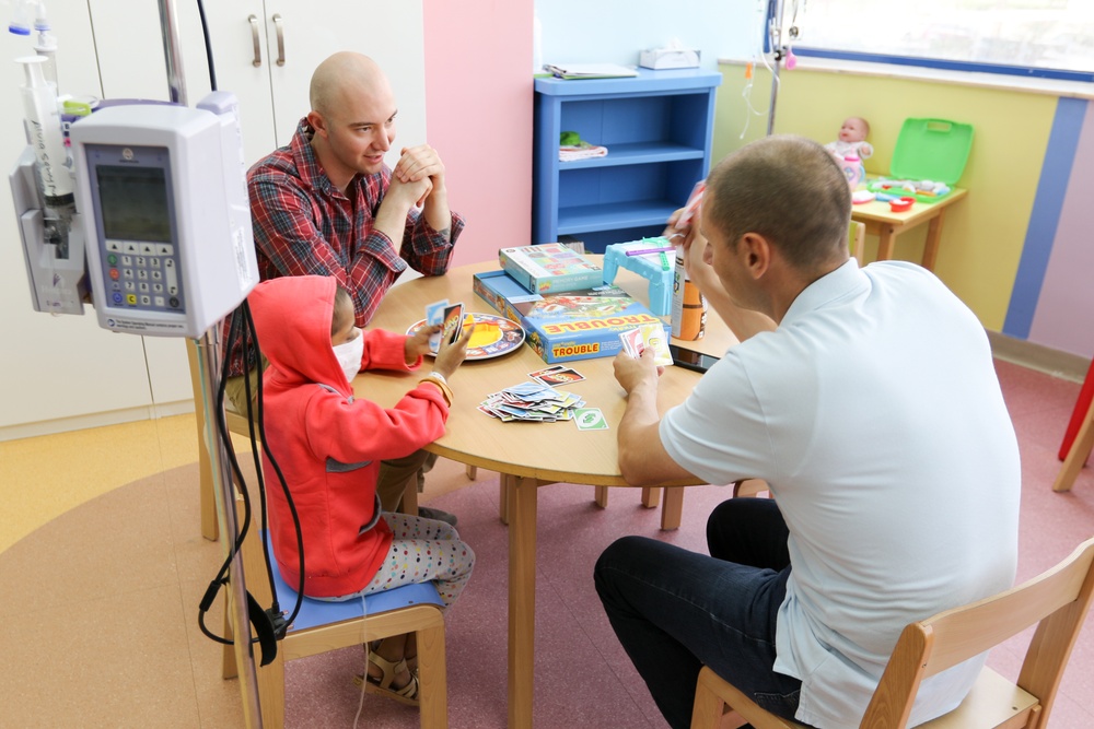 Soldiers spend the day playing with children at Kuwait hospitals