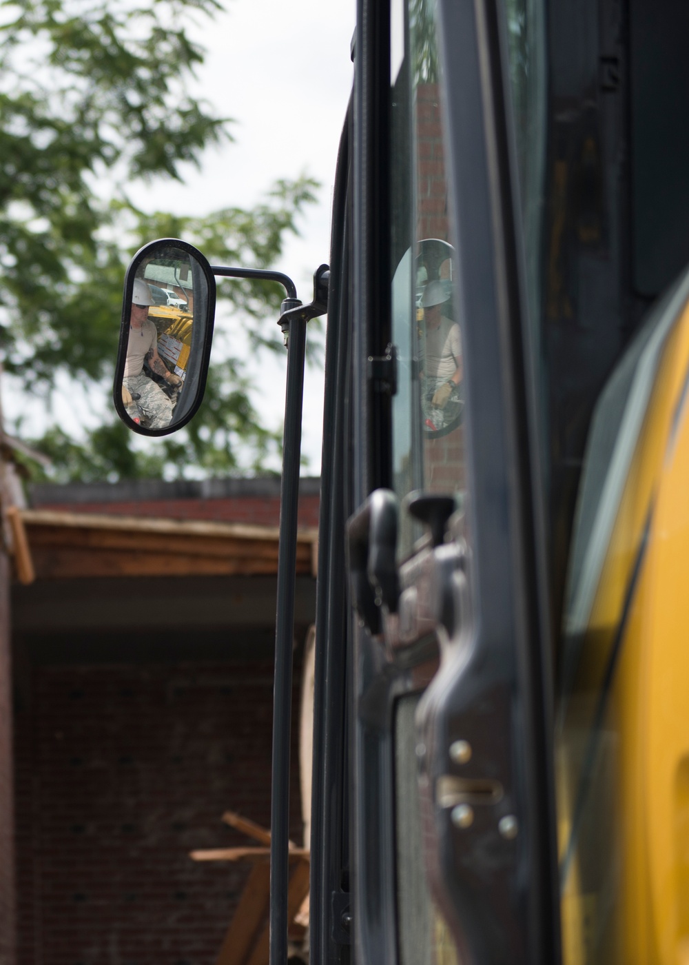 Staff Sgt. Daniel Arnold cleans up waste at the West Virginia Schools for the Deaf and the Blind