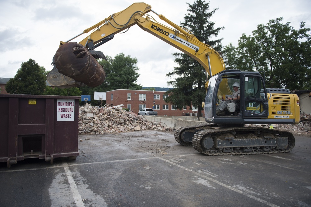 Staff Sgt. Daniel Arnold cleans up waste at the West Virginia Schools for the Deaf and the Blind