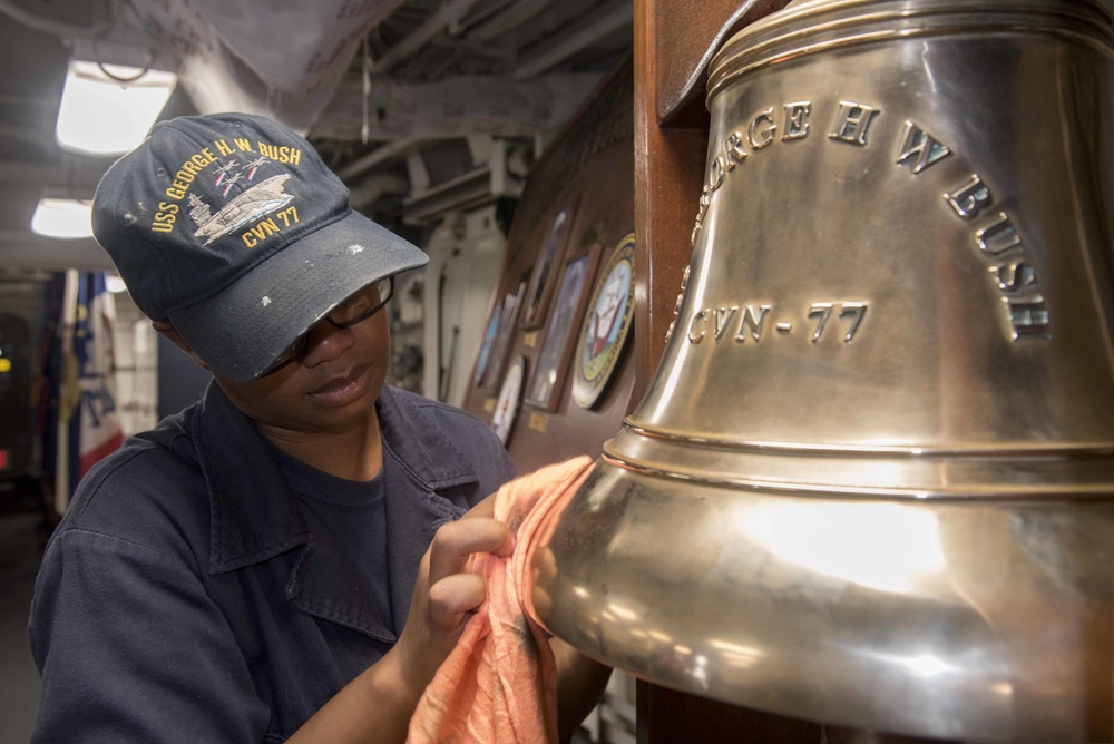 Sailor Shines the Ship's Bell Aboard GHWB