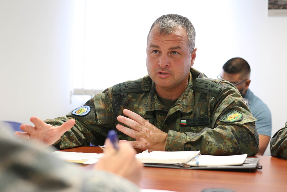 Members of the U.S. and Bulgarian Armed Forces discuss and plan future combined training exercises during a bilateral training conference