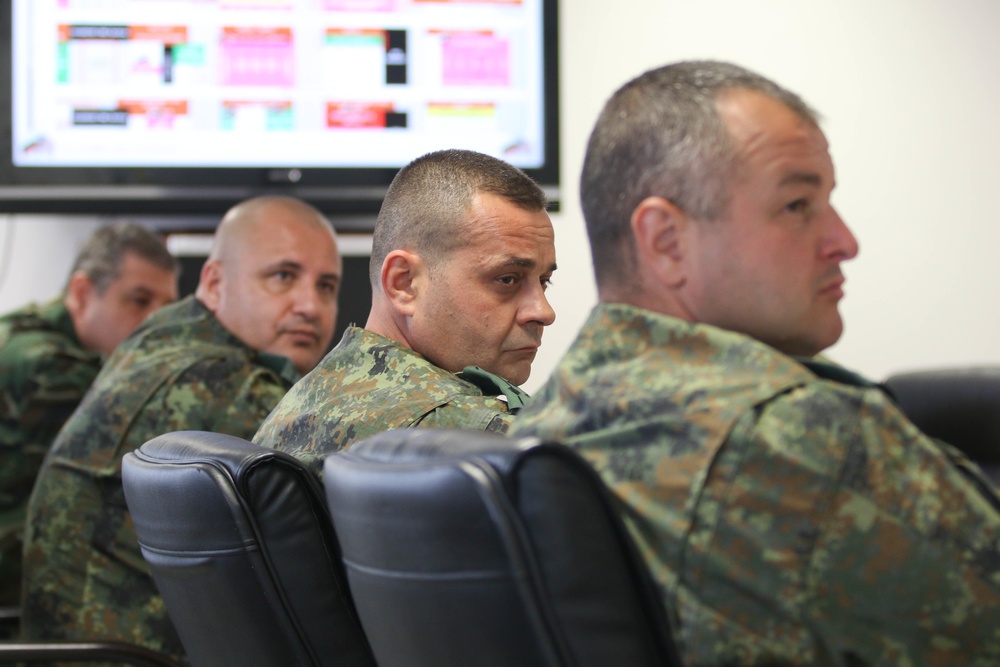 Members of the U.S. and Bulgarian Armed Forces discuss and plan future combined training exercises during a bilateral training conference.