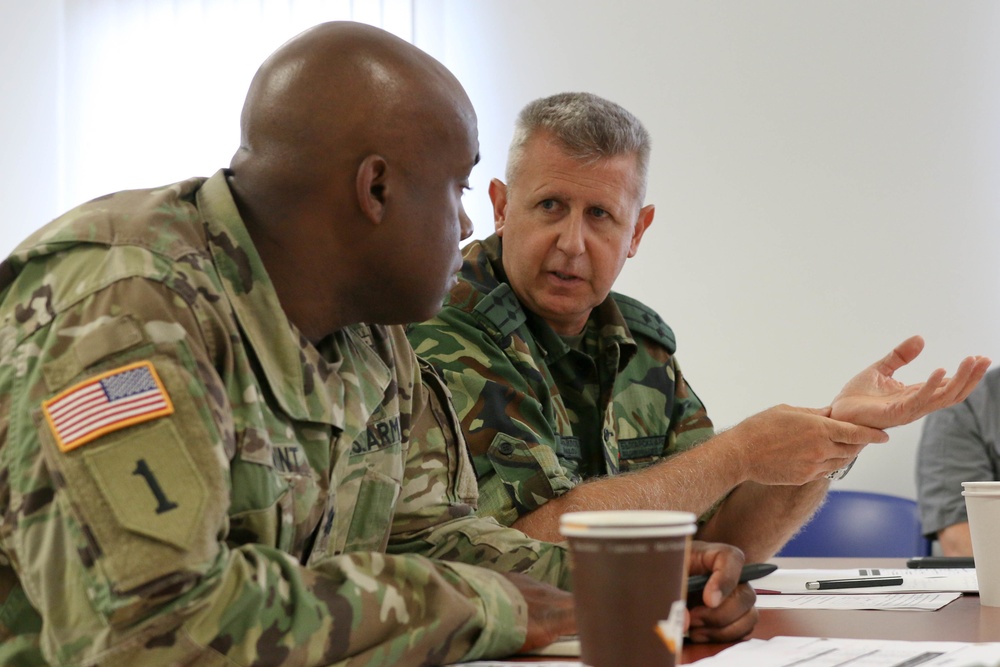 Members of the U.S. and Bulgarian Armed Forces discuss and plan future combined training exercises during a bilateral training conference