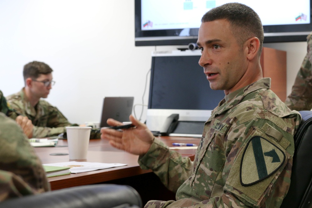 Members of the U.S. and Bulgarian Armed Forces discuss and plan future combined training exercises during a bilateral training conference.