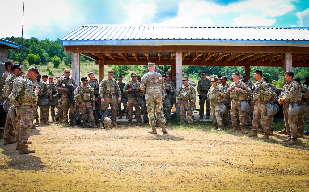 Army Col. Wilson Rutherford speaks to his troops in the field