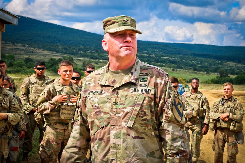 Army Col. Wilson Rutherford speaks to his troops in the field