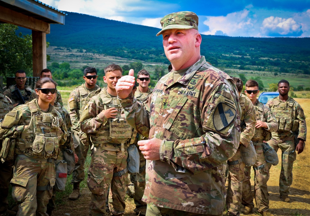 Army Col. Wilson Rutherford speaks to his troops in the field