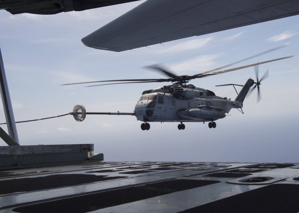 Marine C-130 refuels CH-53 mid-flight during RIMPAC