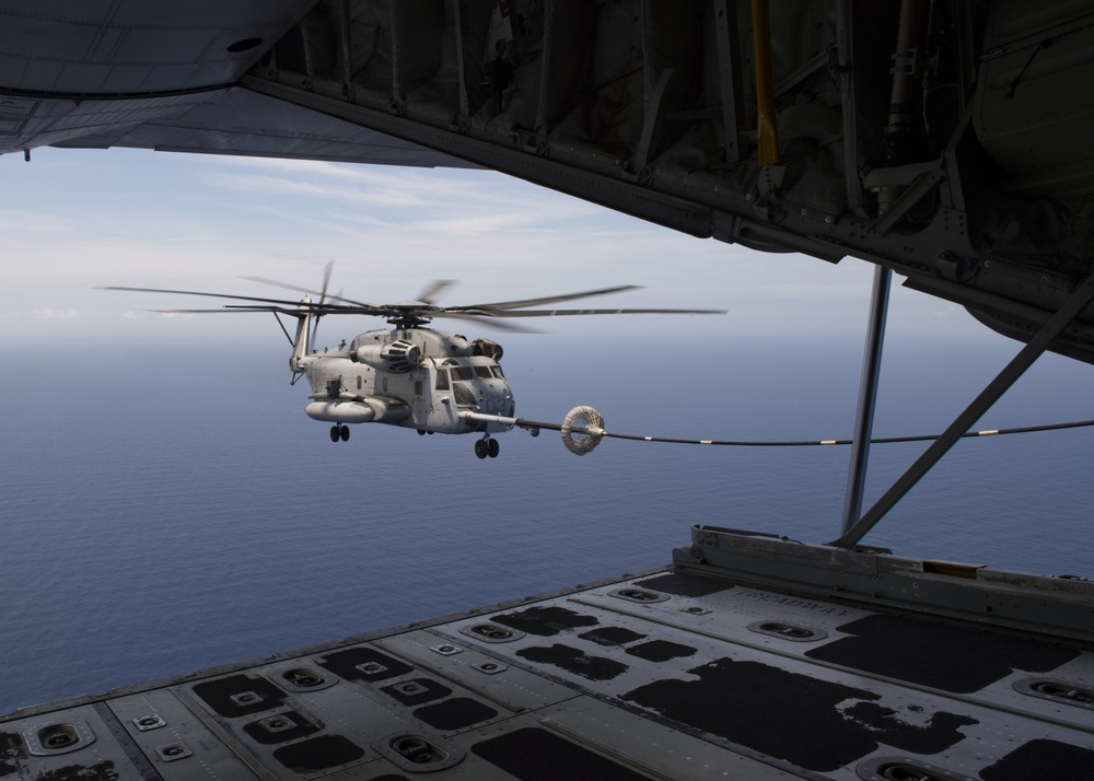 Marine C-130 refuels CH-53 mid-flight during RIMPAC