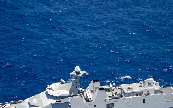An aerial photograph of a naval warship with hull number 331 underway on open blue ocean. The vessel is a modern grey-painted frigate or corvette featuring a helicopter deck at the stern marked with an 'H' landing circle and the letters 'REM'. The ship is equipped with various weapon systems, radar arrays, and sensor masts visible along its superstructure.
