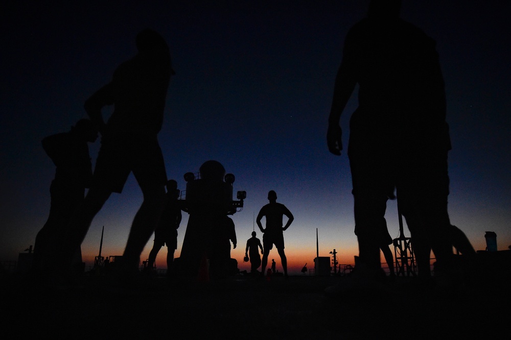 Sailors aboard the USS Mount Whitney (LCC 20) conduct a sunrise physical training session in the Mediterrranean Sea.