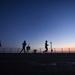 Sailors aboard the USS Mount Whitney (LCC 20) conduct a sunrise physical training session in the Mediterrranean Sea.