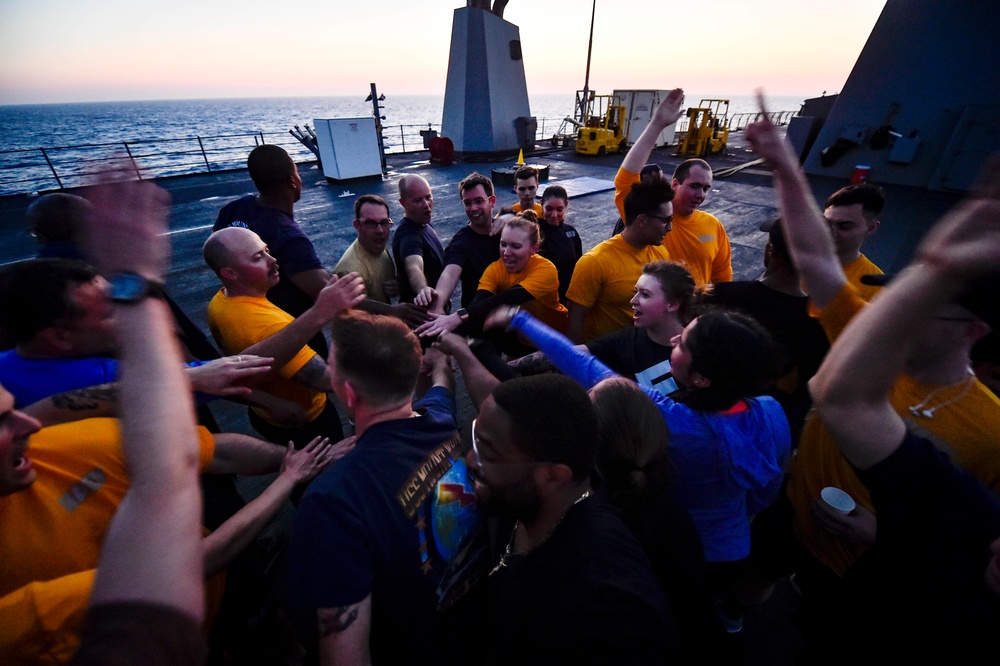 Sailors aboard the USS Mount Whitney (LCC 20) conduct a sunrise physical training session in the Mediterrranean Sea.