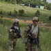 Charlie Company, 100th Infantry Regiment, storms the objective on a live fire range