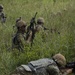 Charlie Company, 100th Infantry Regiment, storms the objective on a live fire range