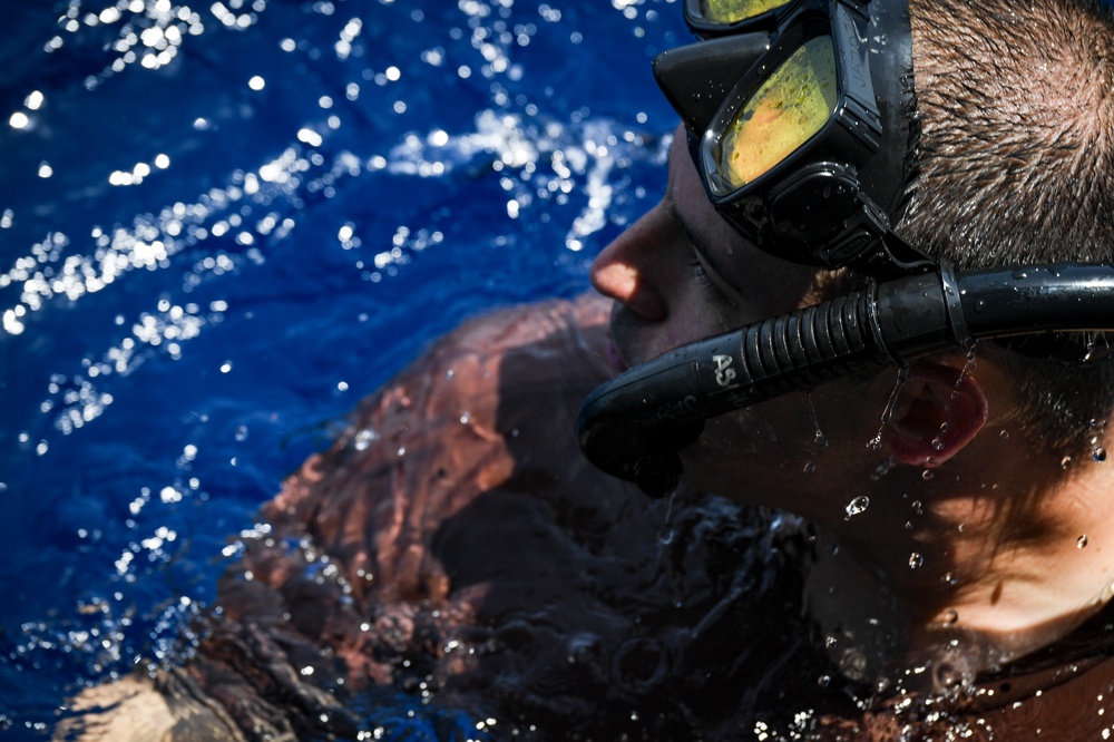 Sailors and Military Sealift Command civil service mariners participate in a swim call aboard the USS Mount Whitney (LCC 20) in in the Mediterrranean Sea.