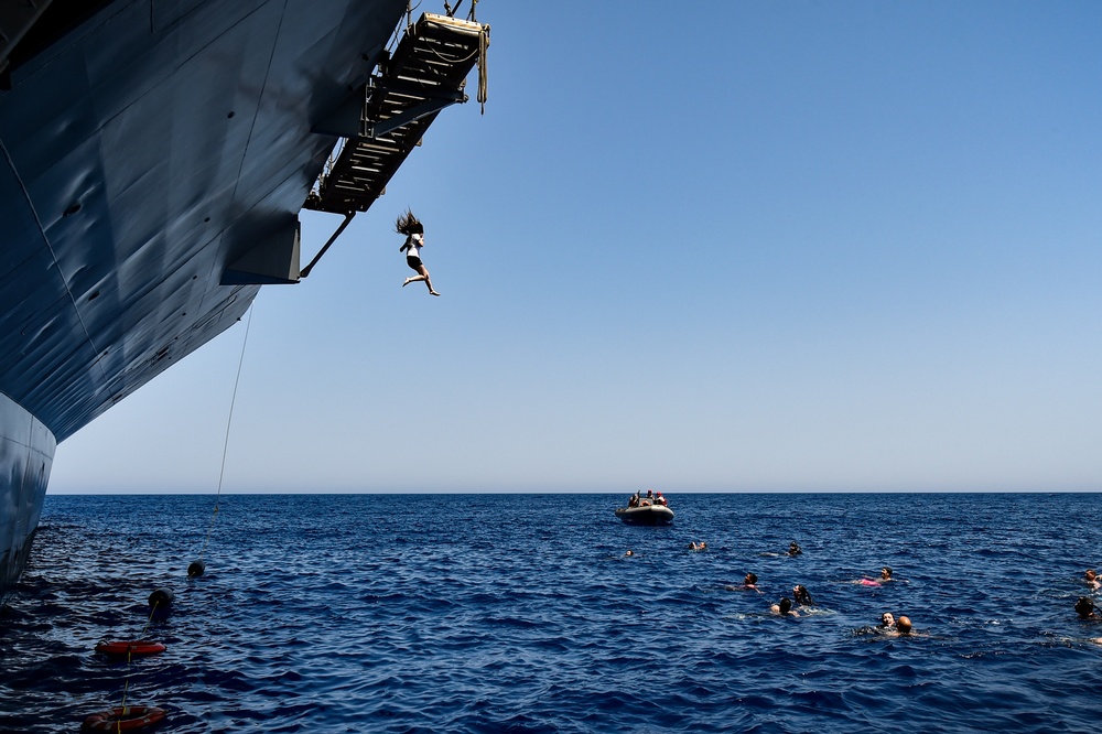 Sailors and Military Sealift Command civil service mariners participate in a swim call aboard the USS Mount Whitney (LCC 20) in in the Mediterrranean Sea.