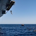 Sailors and Military Sealift Command civil service mariners participate in a swim call aboard the USS Mount Whitney (LCC 20) in in the Mediterrranean Sea.