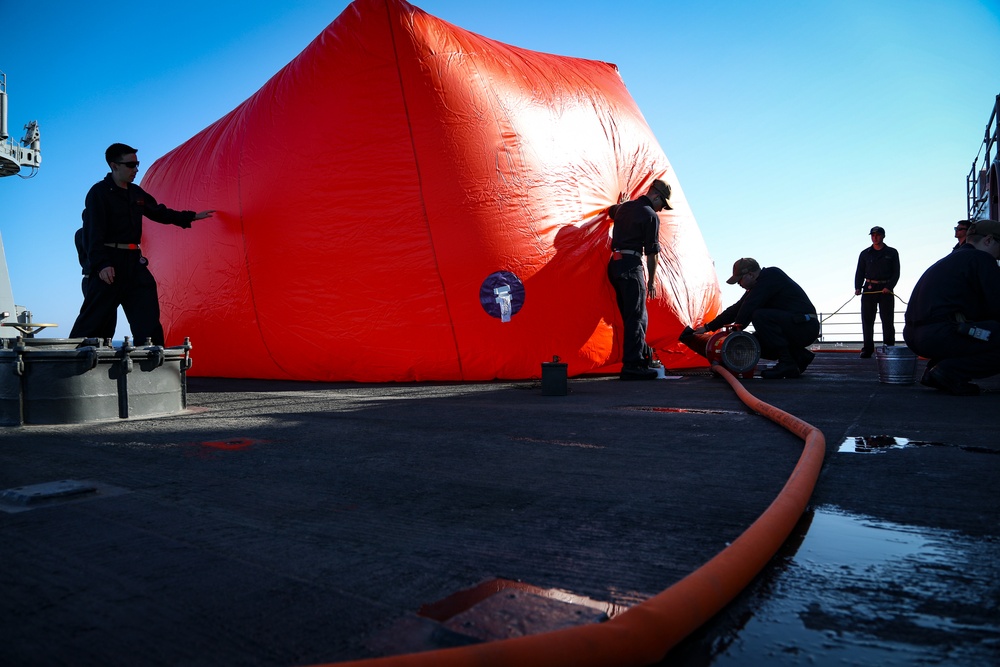 Sailors inflate a 'killer tomato' inflatable target during crew served weapons training aboard the Blue Ridge-class command and control ship USS Mount Whitney (LCC 20) in the Mediterranean Sea, July 21.