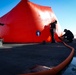 Sailors inflate a 'killer tomato' inflatable target during crew served weapons training aboard the Blue Ridge-class command and control ship USS Mount Whitney (LCC 20) in the Mediterranean Sea, July 21.