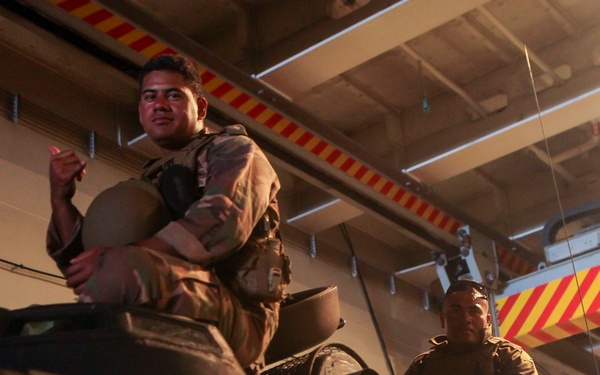 Tonga marines return to HMAS Adelaide during RIMPAC