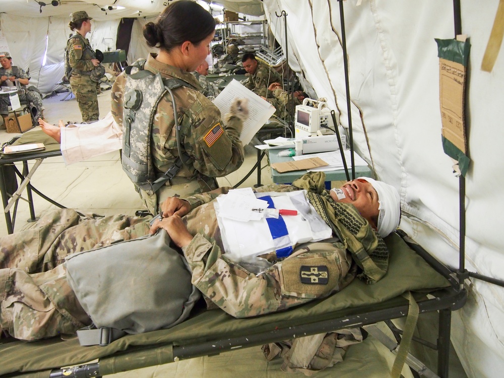 U.S. Army Reserve Soldiers with 228th Combat Support Hospital, based out of San Antonio, Texas, provide medical care for a simulated patient in a surgical cut suit during Global Medic CSTX 91-18-01, at Fort Hunter Liggett, California, July 21, 2018.