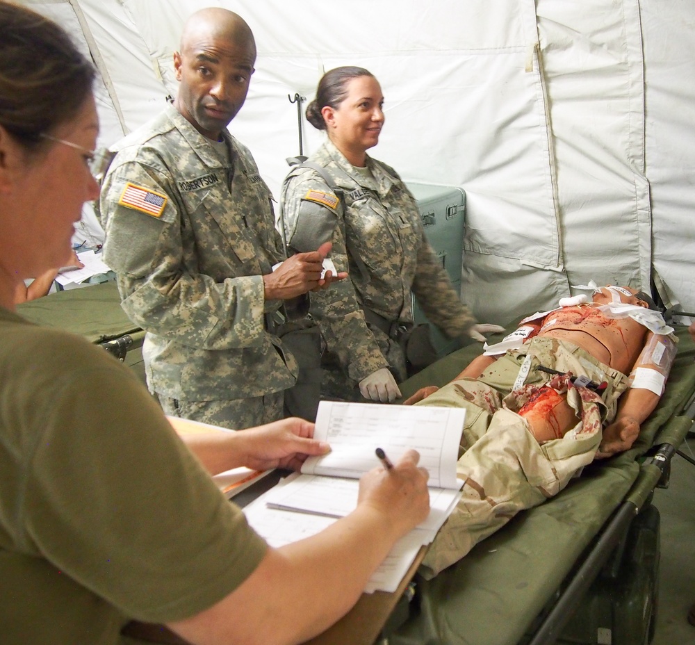 U.S. Army Reserve Soldiers assigned to 228th Combat Support Hospital, based out of San Antonio, Texas, provide medical care for a simulated patient during Global Medic CSTX 91-18-01