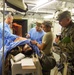 U.S. Army Reserve Soldiers assigned to 228th Combat Support Hospital, based out of San Antonio, Texas, provide medical care for a simulated patient in a Cut Suit during Global Medic CSTX 91-18-01