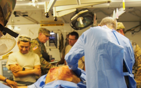 U.S. Army Reserve Soldiers assigned to 228th Combat Support Hospital, based out of San Antonio, Texas, provide medical care for a simulated patient in a Cut Suit during Global Medic CSTX 91-18-01