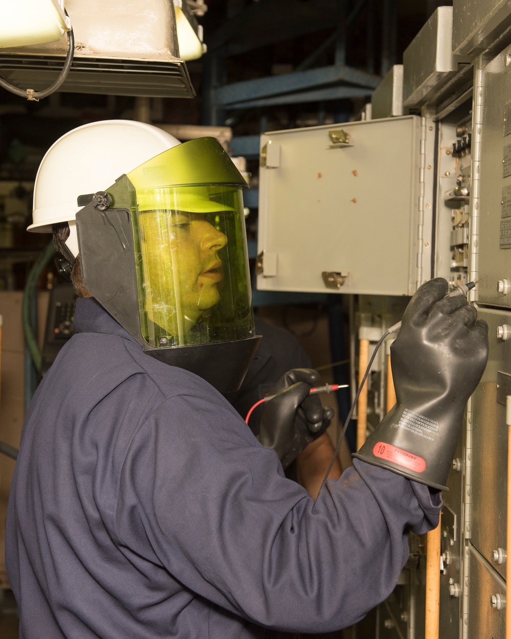 Sailors do maintenance on the Ohio-class ballistic submarine USS Alaska