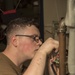 Sailors do maintenance on the Ohio-class ballistic submarine USS Alaska