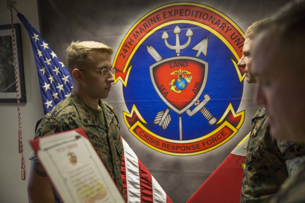 A 24th Marine Expeditionary Unit Marine meritoriously receives a new rank