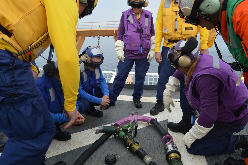 Coast Guard Cutter Healy crew members train to refuel helicopters