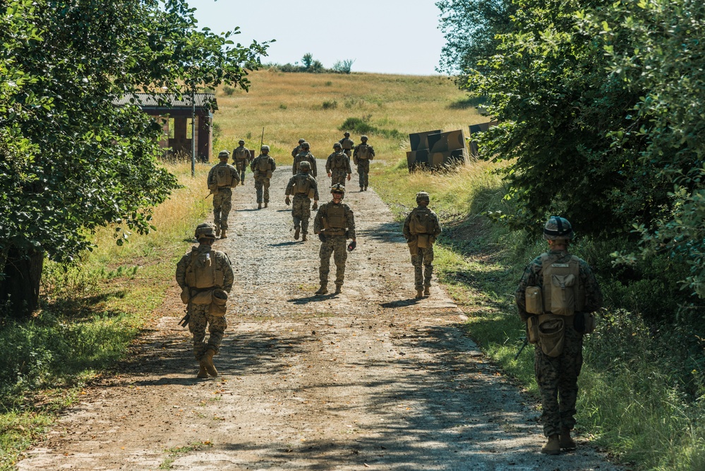 Marines dismounts maneuvering to an objective